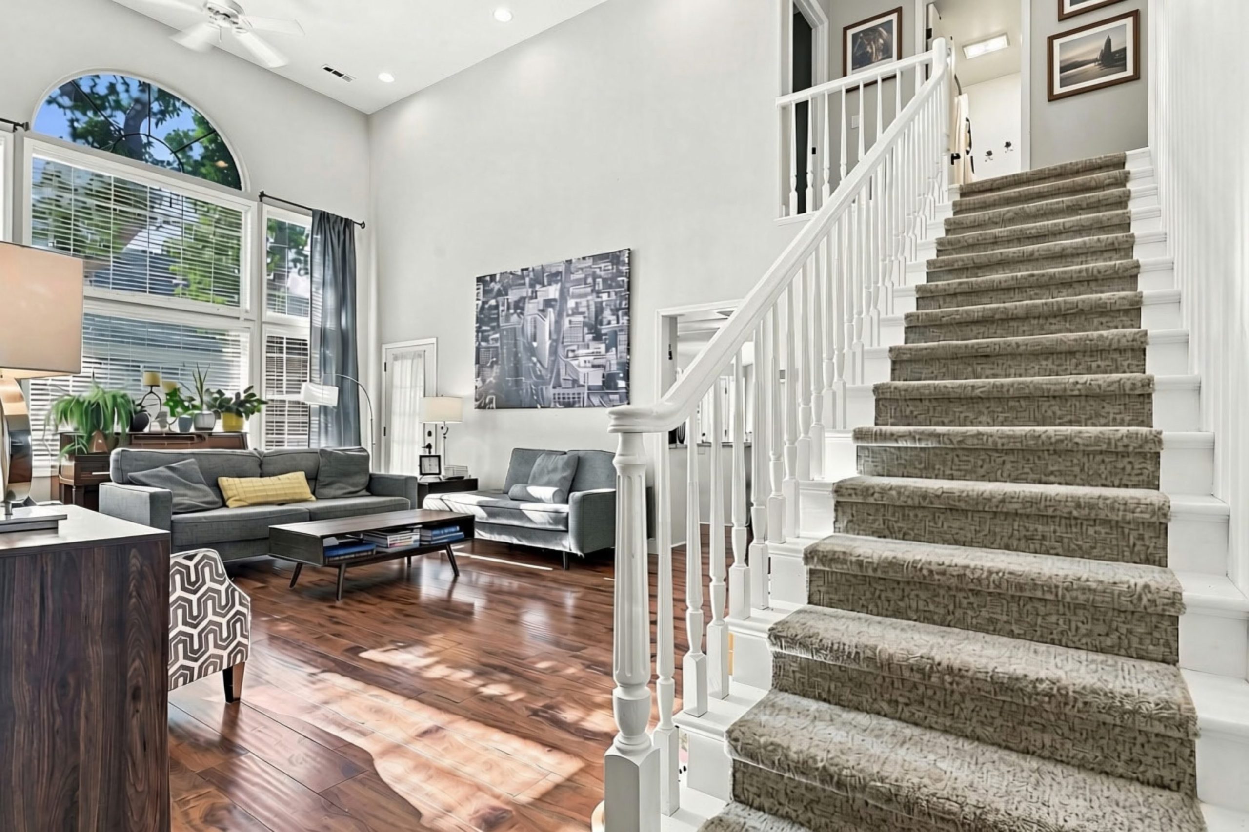 Great room and staircase with wood floors at 947 Brandon Street