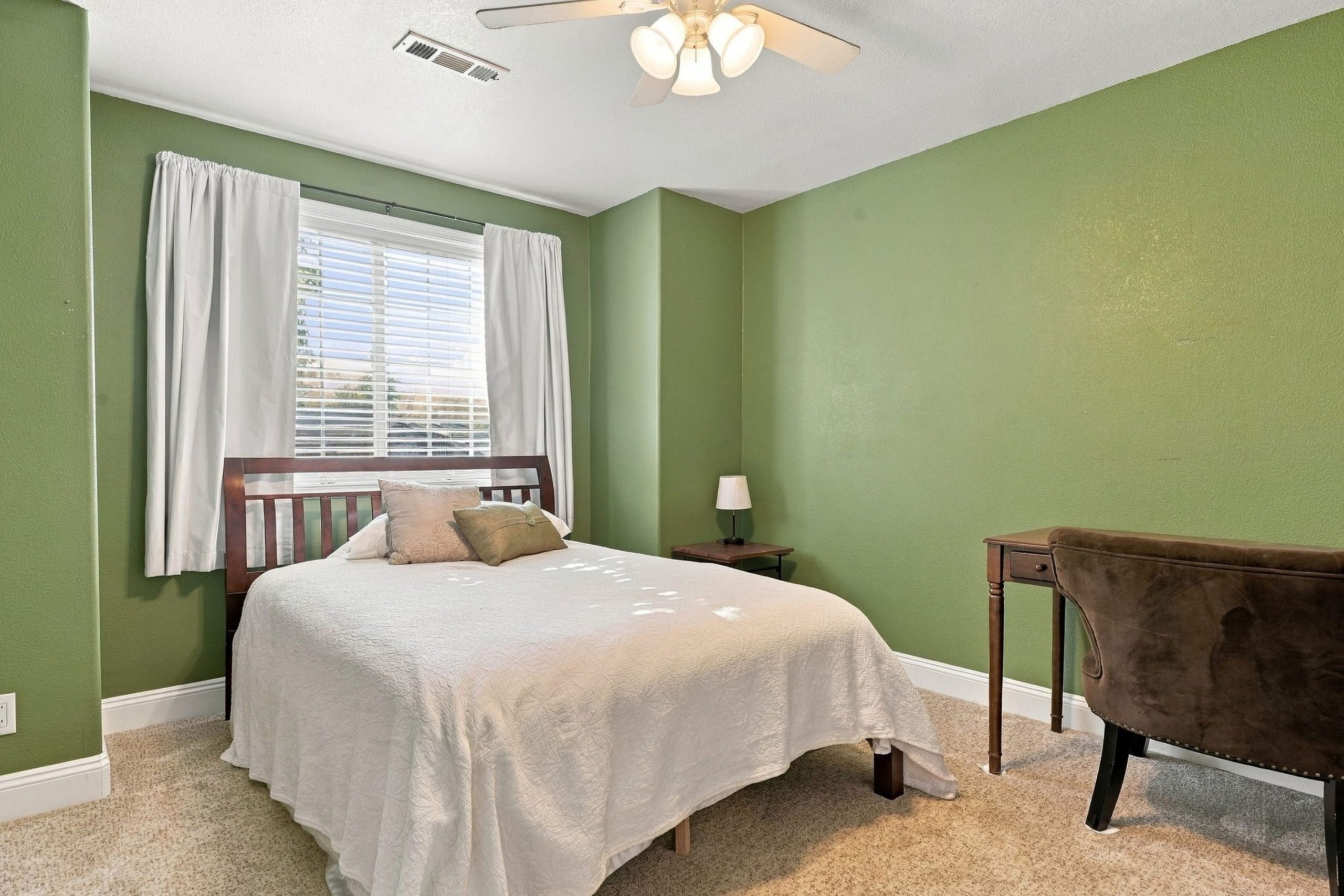 Bedroom with green accent wall at 947 Brandon Street