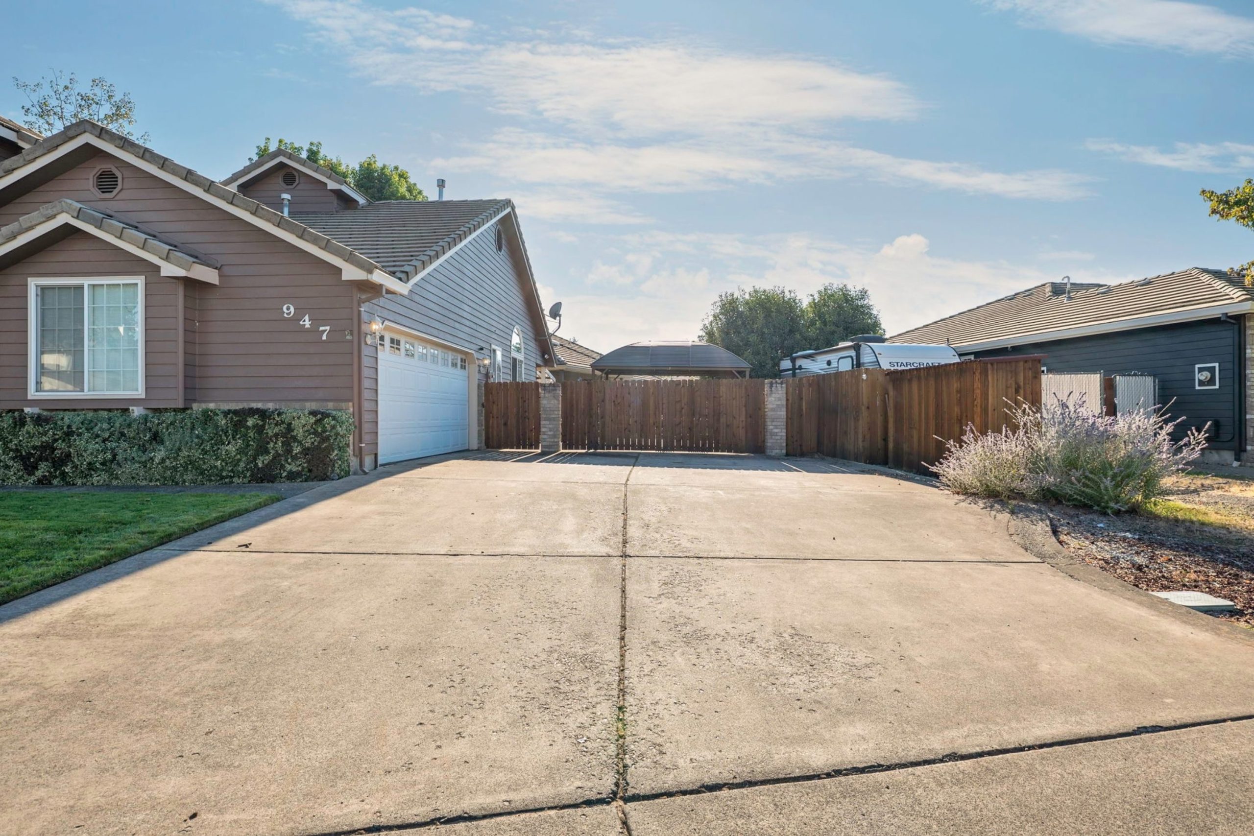 Driveway and garage with fenced RV parking at 947 Brandon Street