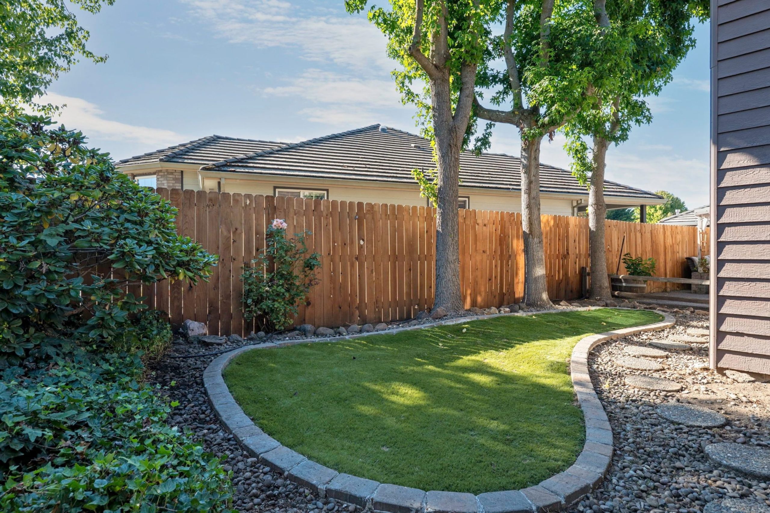 Fenced side yard with lawn at 947 Brandon Street